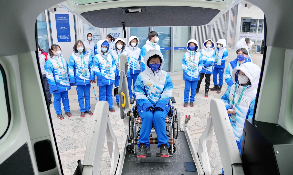 Volunteers try the barrier-free facilities at the Beijing 2022 Winter Paralympic Games. Photo: VCG