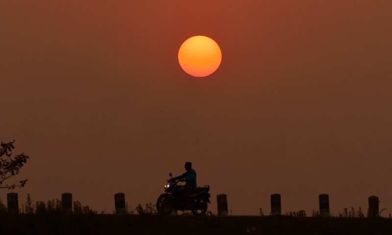 A man rides his motorcycle in Nagaon district of India's northeastern state of Assam, March 5, 2022.Photo:Xinhua