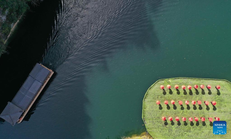 Aerial photo taken on March 7, 2022 shows a ship sailing across Baofeng Lake of Wulingyuan District in Zhangjiajie, central China's Hunan Province. (Photo by Wu Yongbing/Xinhua)