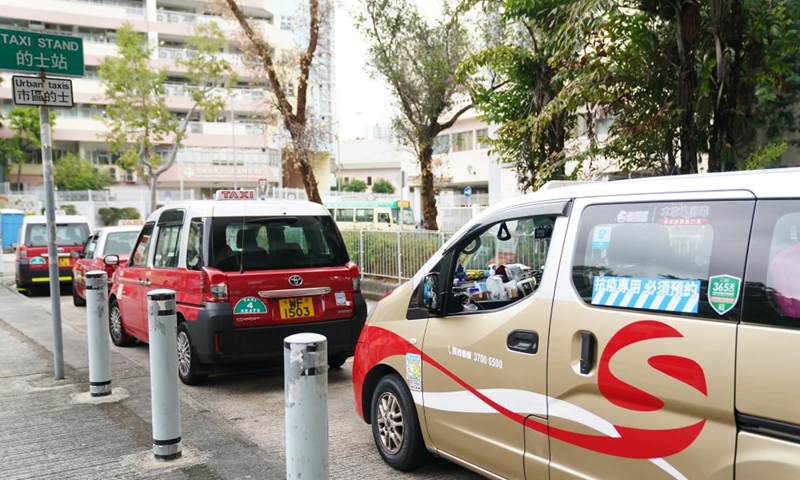 Taxies of the anti-epidemic taxi fleet stand by along a street in Hong Kong, south China, Feb. 18, 2022.Photo:Xinhua