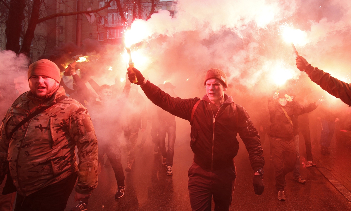 Members of Azov Battalion hold flares during a protest in Kiev on March 1, 2016. Photo: AFP