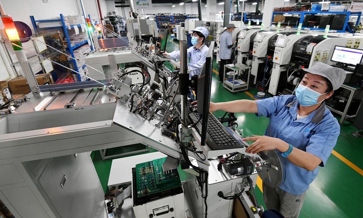 A worker checks a chip at Jade Bird Fire Co in Zhangjiakou, North China's Hebei Province, on March 27, 2022. Jade Bird makes firefighting products. Its self-developed Zhuhuan chip, which integrates fire detection capability, communication technology and integrated circuit technology, is widely used in China. Photo: VCG