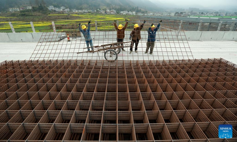 Laborers work at a construction site of the Guiyang-Nanning high-speed railway in southwest China's Guizhou Province, March 6, 2022.(Photo by Xiao Wei/Xinhua)