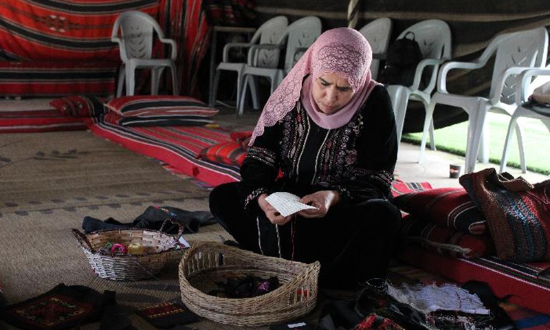 A Bedouin woman works on embroidery in the visitor center in Lakiya, Israel on Feb. 27, 2022.Photo:Xinhua