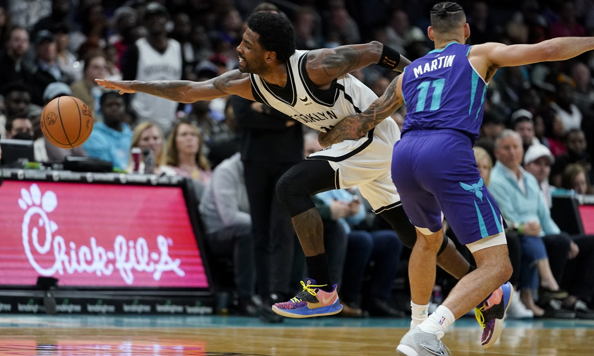 Brooklyn Nets guard Kyrie Irving (left) is fouled by Charlotte Hornets forward Cody Martin on March 8, 2022, in Charlotte, North Carolina. Photo: VCG