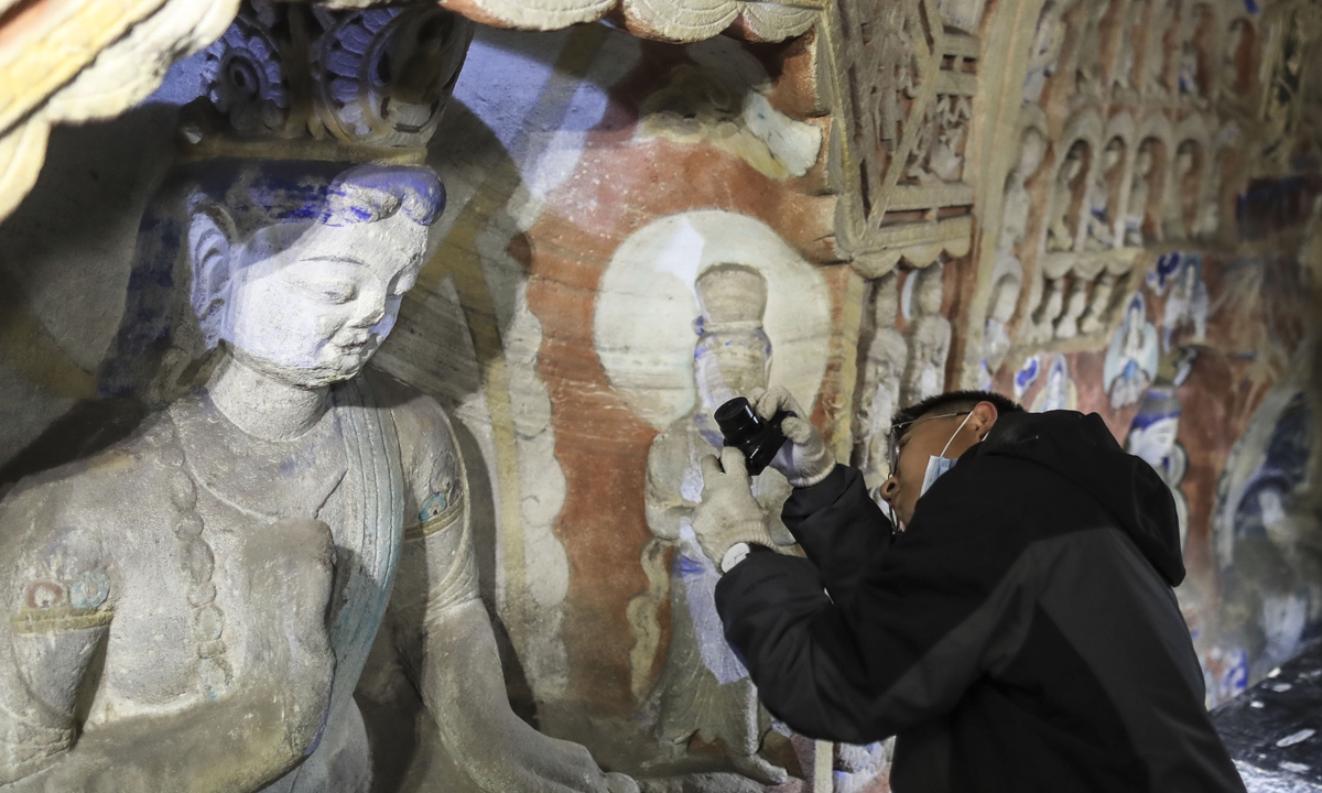 Visitors take a tour of a replica of the Yungang Grottoes made with 3D printing and high-fidelity digital technology in Hangzhou, East China's Zhejiang Province, on November 3, 2020. Photos: IC