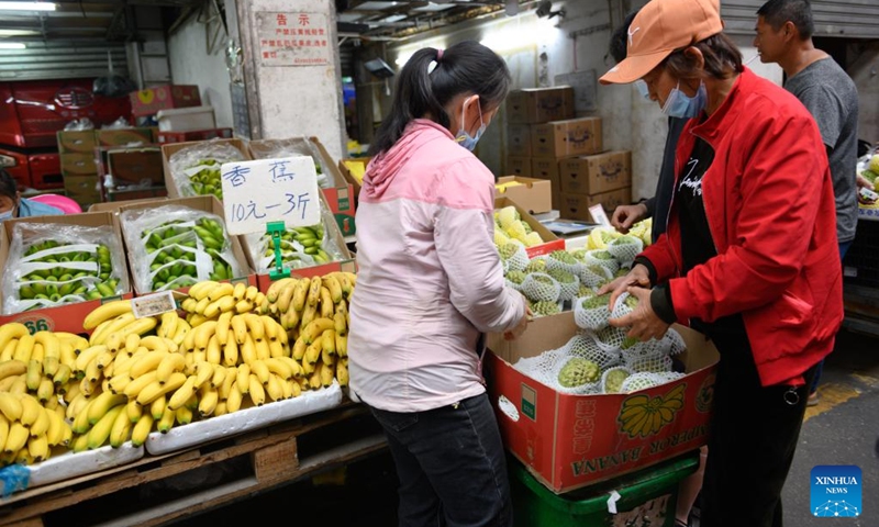 Customers select custard apples at a local market in Haikou, south China's Hainan Province, March 8, 2022.(Photo: Xinhua)