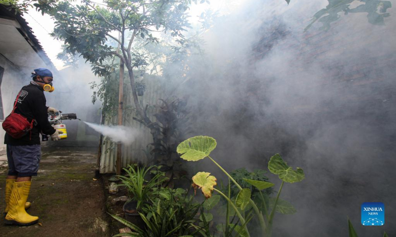 A worker sprays anti-mosquito fog to prevent the spread of dengue fever at a residential area in Surakarta, Central Java, Indonesia, March 10, 2022. (Photo by Bram Selo/Xinhua)