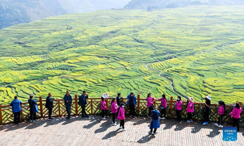 Tourists view the scenery of cole flower fields in Panzhou, southwest China's Guizhou Province, March 7, 2022. (Xinhua/Yang Wenbin)
