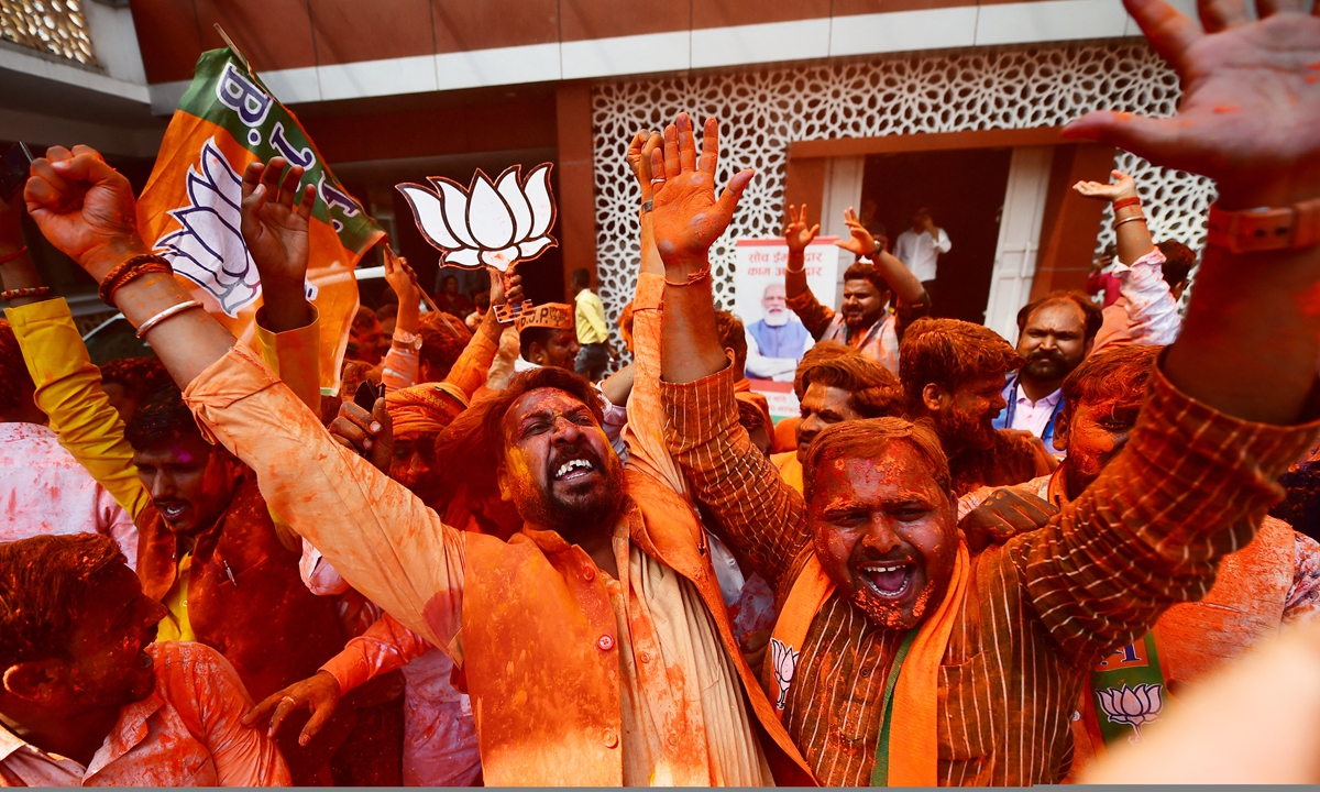 Supporters of India's Bharatiya Janata Party (BJP) celebrate outside the party office in Lucknow, India on March 10, 2022, on the day of counting of votes for the Uttar Padesh state asembly elections. Photo: AFP