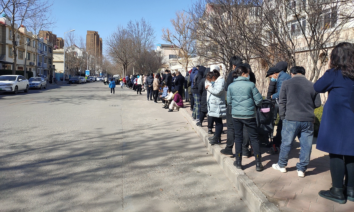 Residents line to take nucleic acid tests in a community in Laixi, East China's Shandong Province on March 5, 2022. Photo: VCG
