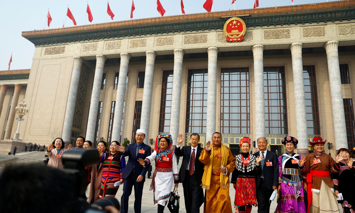 Delegates pose outside the Great Hall of the People after the closing session of the Chinese People's Political Consultative Conference (CPPCC) in Beijing, China March 10, 2022.Photo: IC