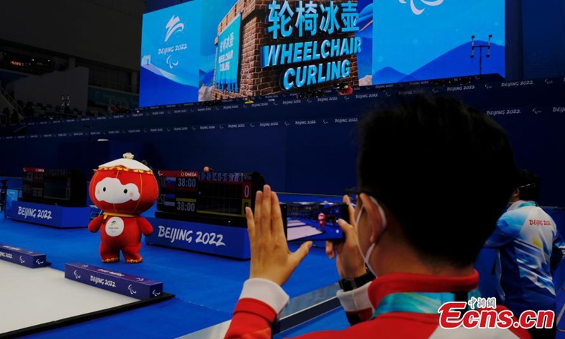 Shuey Rhon Rhon, the red lantern-shaped mascot of Beijing 2022 Winter Paralympic Games, appears at the National Aquatics Center, also known as the Ice Cube, venue of wheelchair curling competition of the Games in Beijing, March 10, 2022. Photo:China News Service