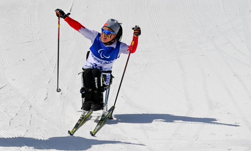 Yang Hongqiong of China celebrates after the Para Cross-Country Skiing Women's Long Distance Sitting of Beijing 2022 Winter Paralympics at National Biathlon Center in Zhangjiakou, north China's Hebei Province, March 6, 2022.Photo:Xinhua
