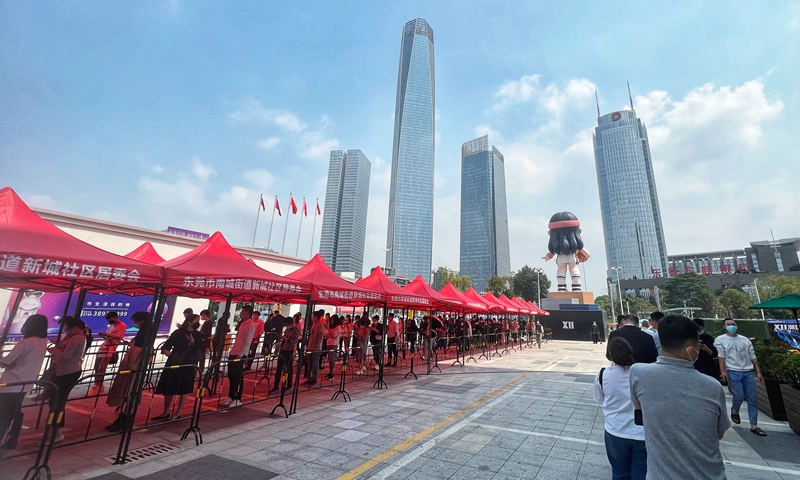 Local residents in Dongguan, South China's Guangdong Province, queue up for a nucleic acid test on a plaza on March 11, 2022. Photo: VCG
