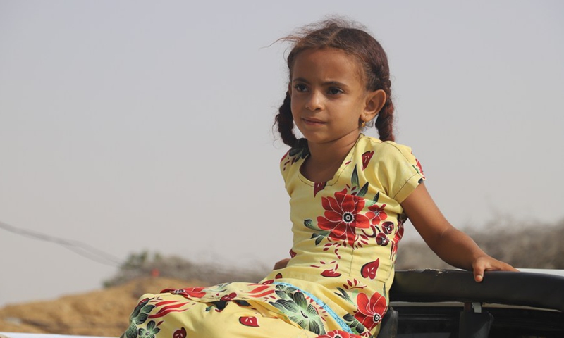 A Yemeni girl sits on a truck outside a charity in Midi district, Hajjah province, Yemen, on March 7, 2022.Photo:Xinhua