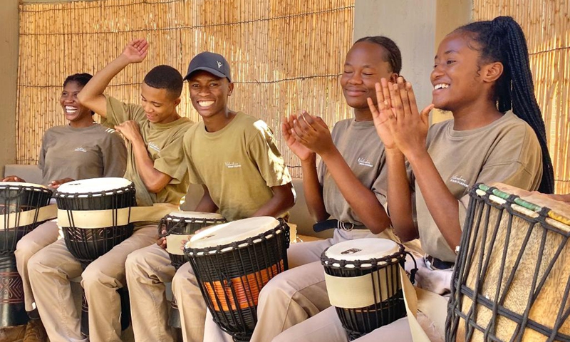 Participants beat drums during the Hit the Beat event at Wolwedans Village, located in the desert plains of the NamibRand Nature Reserve in Namibia on March 12, 2022. Young talented individuals from diverse cultures of the world engaged in artistic creativity during the annual Hit the Beat event at Wolwedans Village. (Photo by Musa Zimunya/Xinhua)