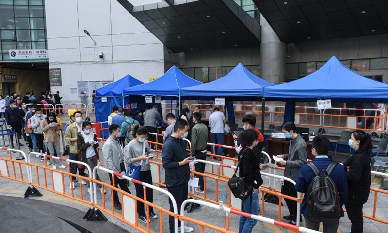People wait in line for nucleic acid tests at a COVID-19 testing site in Huazhong University of Science and Technology Union Shenzhen Hospital (Nanshan Hospital) in Shenzhen, south China's Guangdong Province, Jan. 26, 2021. 