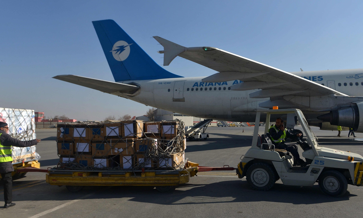 Workers prepare to transport a shipment of COVID-19 vaccines donated by the Chinese government at the airport in Kabul on December 8, 2021. Photo: VCG