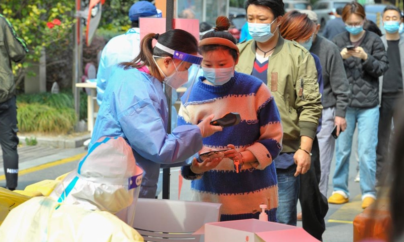 Residents register before receiving nucleic acid tests at a community in east China's Shanghai, March 13, 2022.Photo:Xinhua