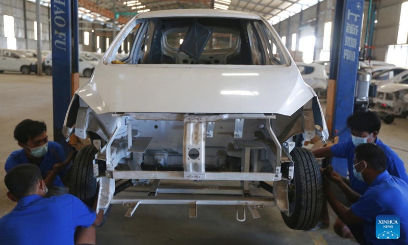 Workers assemble a new energy vehicle at the Khaingkhaing Sangda Motorcar Development Center in Yangon, Myanmar, March 9, 2022.Photo:Xinhua