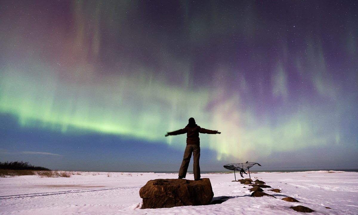 A woman watches the Northern Lights from the shore of Lake Ladoga, Russia on March 14, 2022. The Northern Lights, or the aurora borealis, are natural lights display in Earth's sky, predominantly seen in high-latitude regions around the Arctic and Antarctic. Most of the planets in the Solar System, some natural satellites, brown dwarfs, and even comets also host auroras.
Photo: VCG