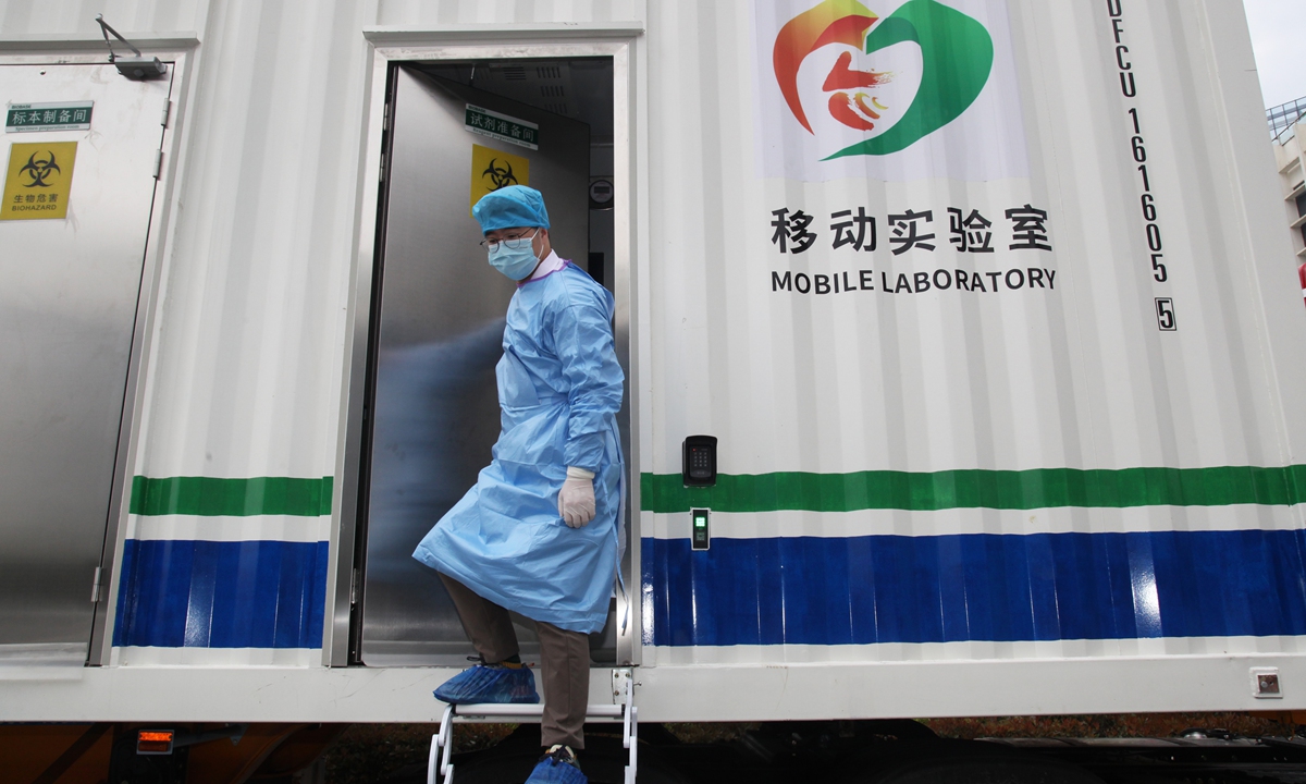 A staff member walks out of a mobile lab for COVID-19 nucleic acid testing in Taizhou,East China's Zhejiang Province on March 17, 2022. Photo: IC