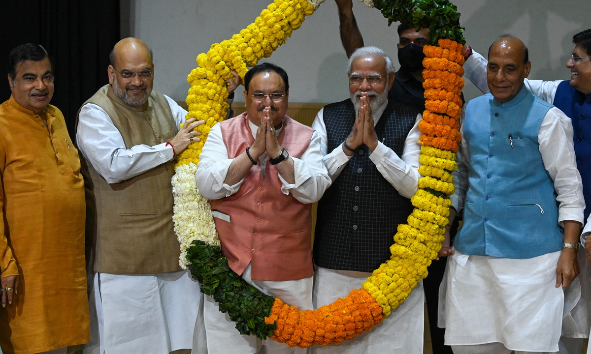 India's Prime Minister Narendra Modi (second right), Bhartiya Janata Party (BJP) president Jagat Prakash Nadda (center), and other party members celebrate their victory in state assembly elections during a BJP parliamentary committee meeting in New Delhi, India on March 15, 2022. Photo: AFP