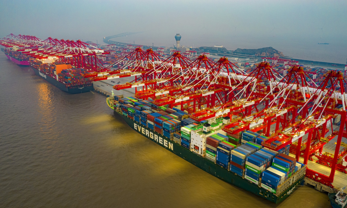 Container vessels berth at the Port of Yangshan to clear cargo around the clock in Shanghai on January 2, 2022. In 2021, the Port of Shanghai handled over 47 million standard containers, ranking first among the world's ports for the 12th consecutive year. Photo: VCG