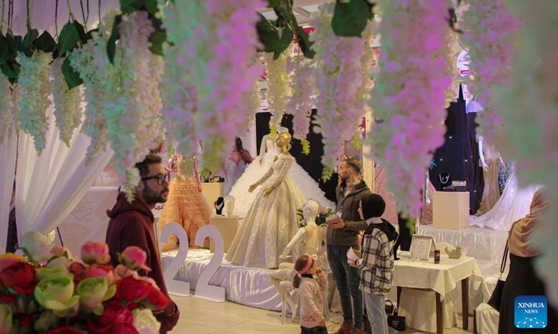 People visit the Your Wedding exhibition which features wedding supplies in Gaza City, March 14, 2022. (Photo by Rizek Abdeljawad/Xinhua)