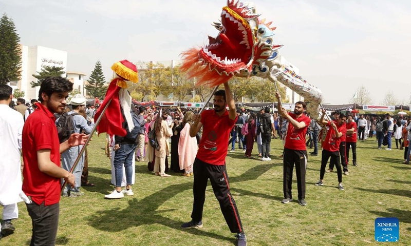 Pakistani students perform dragon dance during an international cultural festival at the National University of Modern Languages (NUML) in Islamabad, capital of Pakistan on March 14, 2022. (Photo: Xinhua)