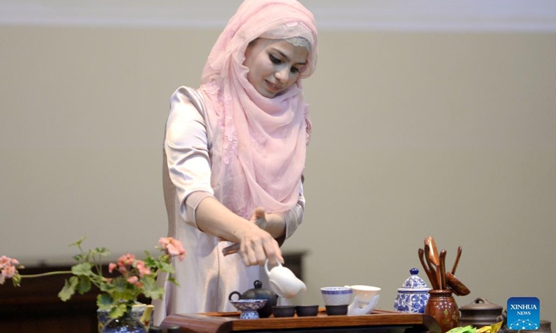 A student performs Chinese tea art during an international cultural festival at the National University of Modern Languages (NUML) in Islamabad, capital of Pakistan on March 14, 2022.(Photo: Xinhua)