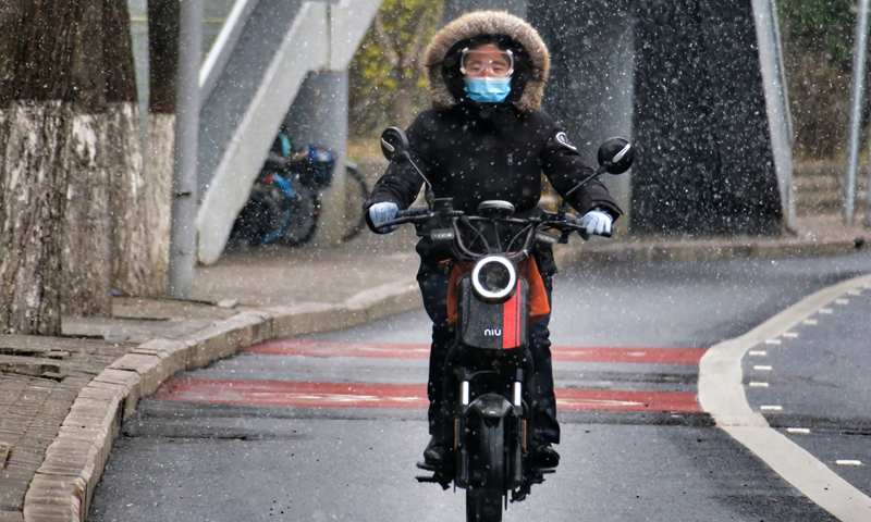 The photo taken on March 17, 2022 shows a local resident riding an electric motorbike in Beijing. Photo: VCG