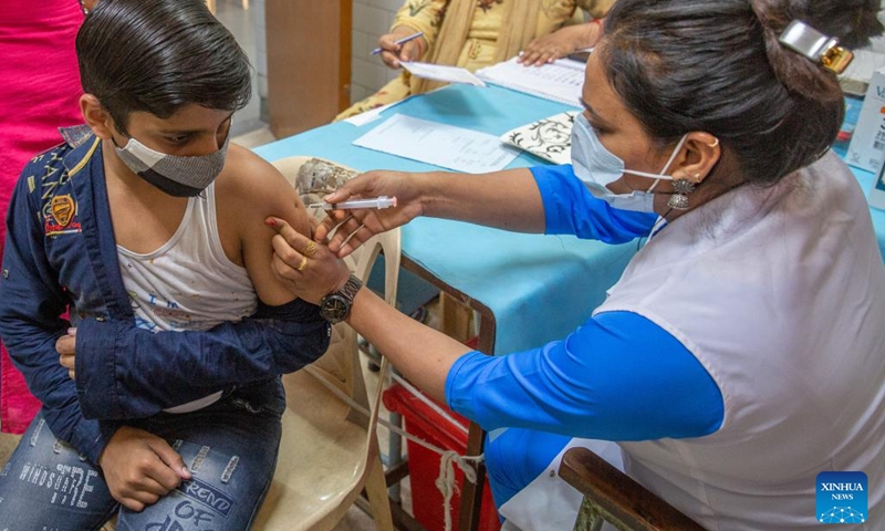 A boy receives a dose of COVID-19 vaccine at a health center in New Delhi, India, March 16, 2022. Vaccination of children in the 12-14 age group began on Wednesday in India.(Photo: Xinhua)