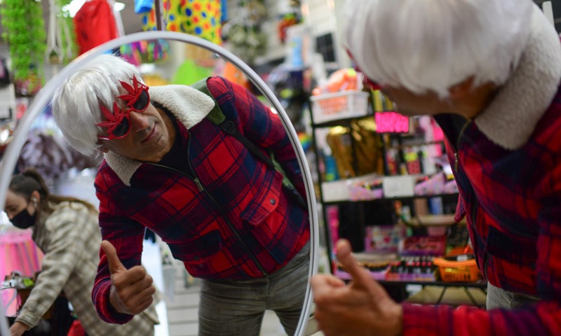 People buy costumes ahead of the Jewish holiday of Purim at a shopping center in Tel Aviv, Israel, on March 14, 2022. Throughout the centuries, Purim has been celebrated to mark the salvation of Jews from the ancient Persian Haman's genocidal plot. It has been traditionally a happy, carnival-like holiday for the Jews.(Photo: Xinhua)