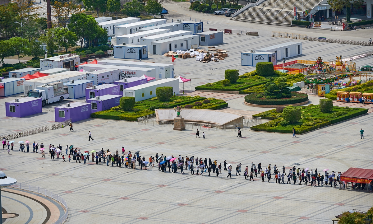 Residents in Quanzhou, Fujian Province wait in line to take nucleic acid tests on March 16. Photo: VCG