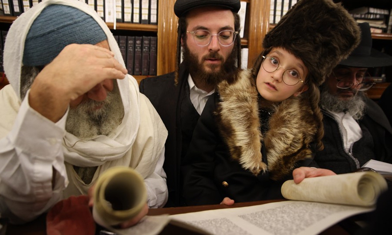 Ultra-Orthodox Jews read the Scroll of Esther during the Jewish holiday of Purim in Meron, northern Israel, on March 16, 2022. Purim is a Jewish holiday commemorating the deliverance of the Jewish people during the reign of the ancient Persian Empire, according to the Jewish biblical story.(Photo: Xinhua)