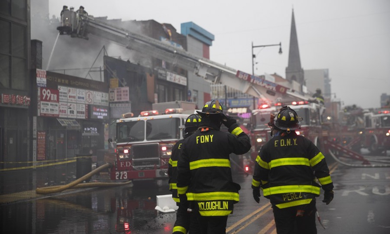 Fire fighters work at the fire site in Flushing of New York, the United States, March 17, 2022.(Photo: Xinhua)