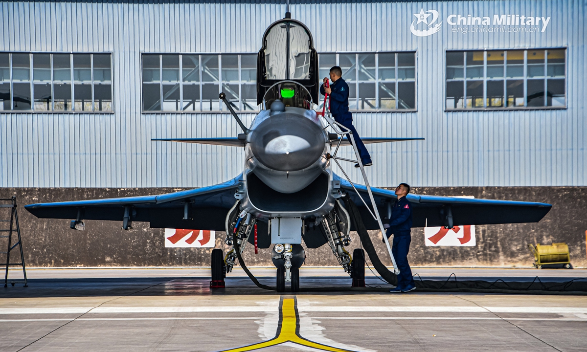 Maintenance men assigned to an aviation brigade of the air force under the PLA Southern Theater Command perform pre-flight inspections on a J-10 fighter jet prior to a round-the-clock flight training exercise on February 14, 2022. Photo:China Military