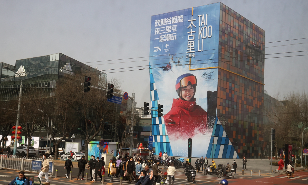 People walk past a billboard featuring Team China's Gu Ailing in Sanlitun, Beijing on March 15, 2022. 
Above: Chinese women's soccer team players attend an event in Hangzhou, Zhejiang Province on March 3, 2022. Photos: VCG