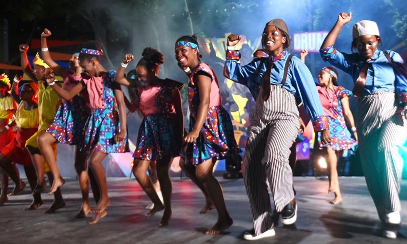 Performers perform during the Cape Town Carnival in Cape Town, South Africa, March 19, 2022. The annual Cape Town Carnival returned to the city Saturday in a new form after a two-year break due to COVID-19, while it maintained a tradition of including performers from the Chinese community and many other groups. (Photo by Xabiso Mkhabela/Xinhua)