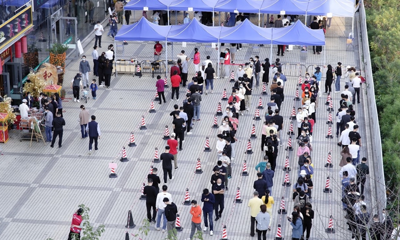 Residents line up for free nucleic acid testing at the special Information Port in Shenzhen's Nanshan district, South China's Guangdong Province. Shenzhen reported 66 local infections on March 13, raising the tally of cases to 432. Photo: IC