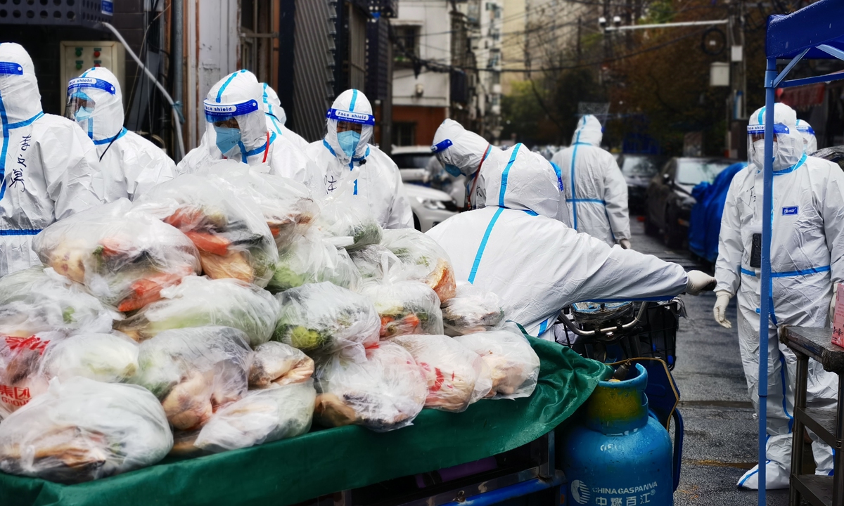 Anti-epidemic workers in Nanjing, East China's Jiangsu Province send life necessities to people who are under sealed management, on March 20, 2022. The city reported 10 silent carriers of coronavirus the previous day. Photo: VCG