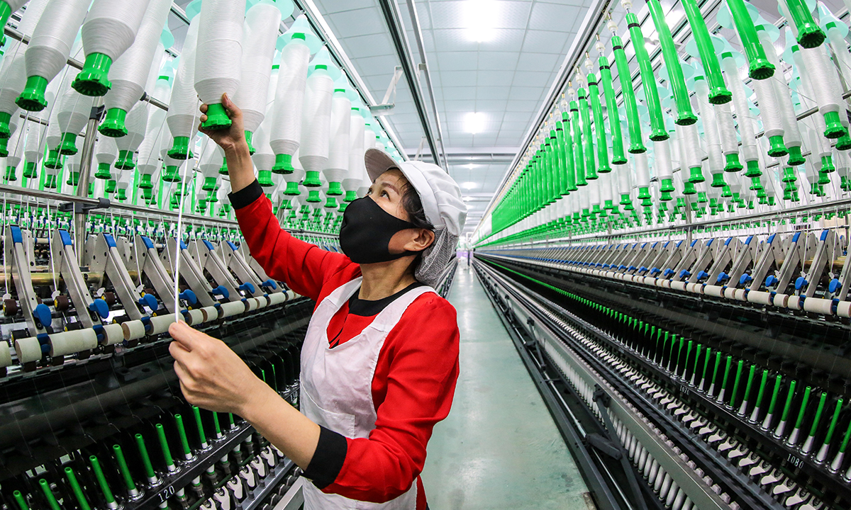 A staffer works at a workshop of Huarui (China) Sewing Thread Co in Ruichang, East China's Jiangxi Province, on March 20, 2022. The company's new production line uses automation and intelligent technical controls throughout the entire process. The company's products sell well at home and abroad. Photo: cnsphoto