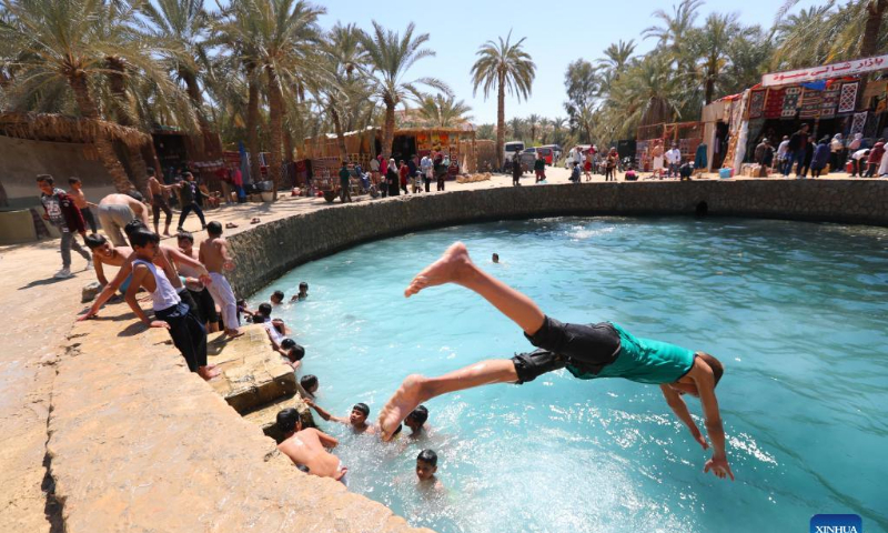 A boy dives into the Cleopatra's Pool at Siwa Oasis in Matrouh Governorate, Egypt, on March 26, 2022. Siwa Oasis lies in Egypt's western desert and there are some 2,000 natural hot springs in which locals love taking a bath. Photo: Xinhua