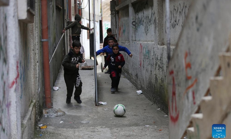 Palestinian refugee children play in an alley at Balata refugee camp in the West Bank city of Nablus, March 16, 2022.Photo:Xinhua