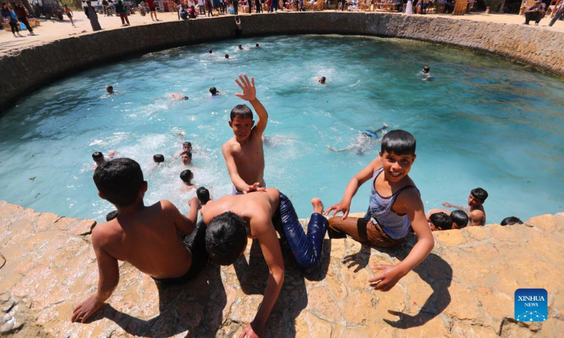 Boys play in the Cleopatra's Pool at Siwa Oasis in Matrouh Governorate, Egypt, on March 26, 2022. Siwa Oasis lies in Egypt's western desert and there are some 2,000 natural hot springs in which locals love taking a bath. Photo: Xinhua