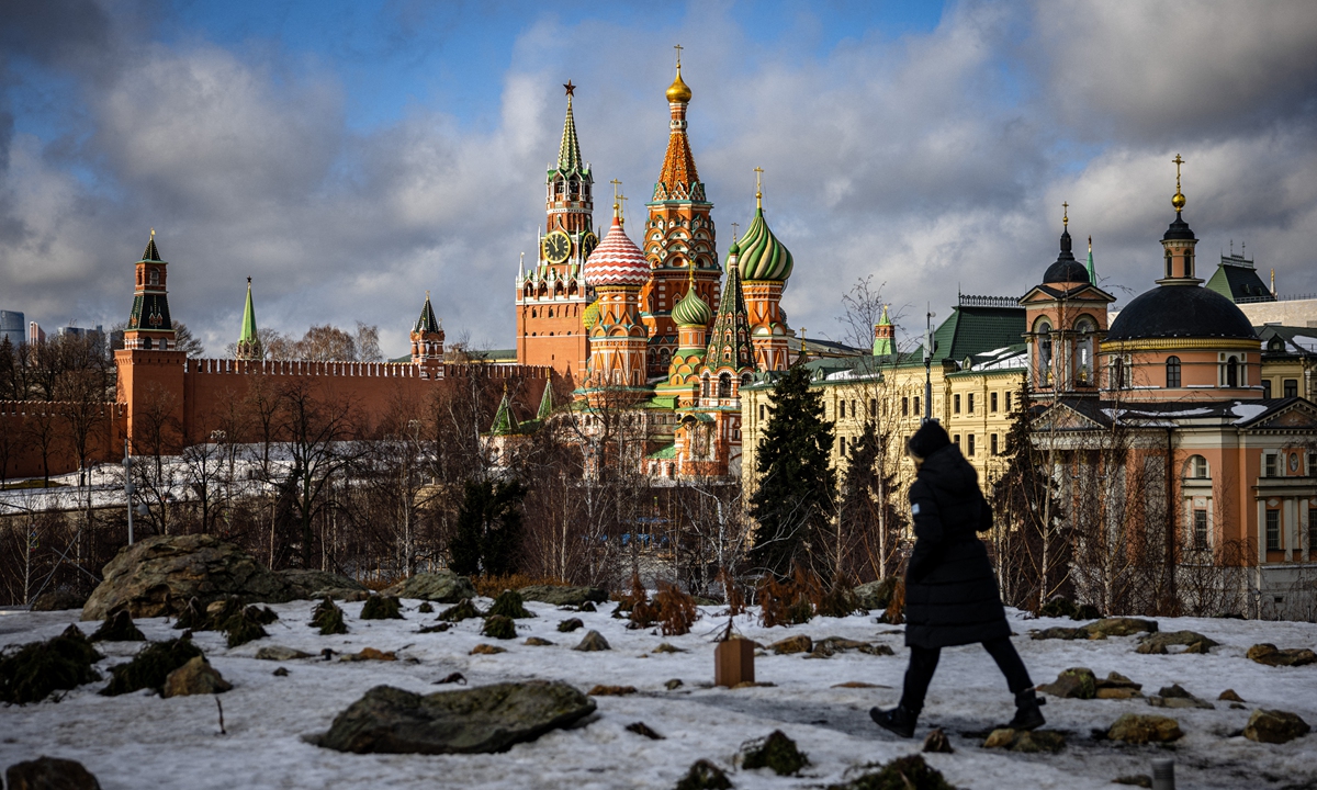 A woman walks outside the Kremlin, Red Square in central Moscow on February 22, 2022. Photo: AFP