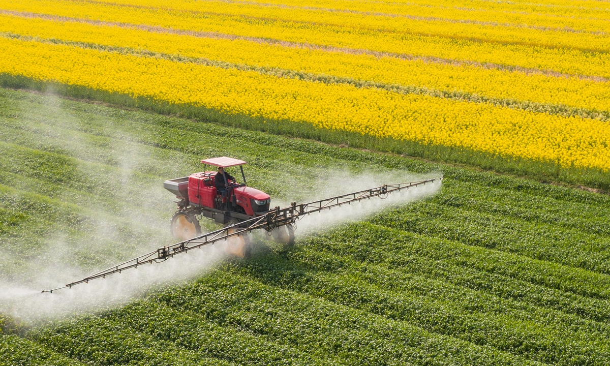 A farmer operates a pesticide sprayer over a wheat field in Nantong, East China’s Jiangsu Province on March 23, 2022. The Chinese government has allocated 20 billion yuan ($3.14 billion) to support farmers who grow grain, among other measures, according to the People’s Daily. Photo: VCG