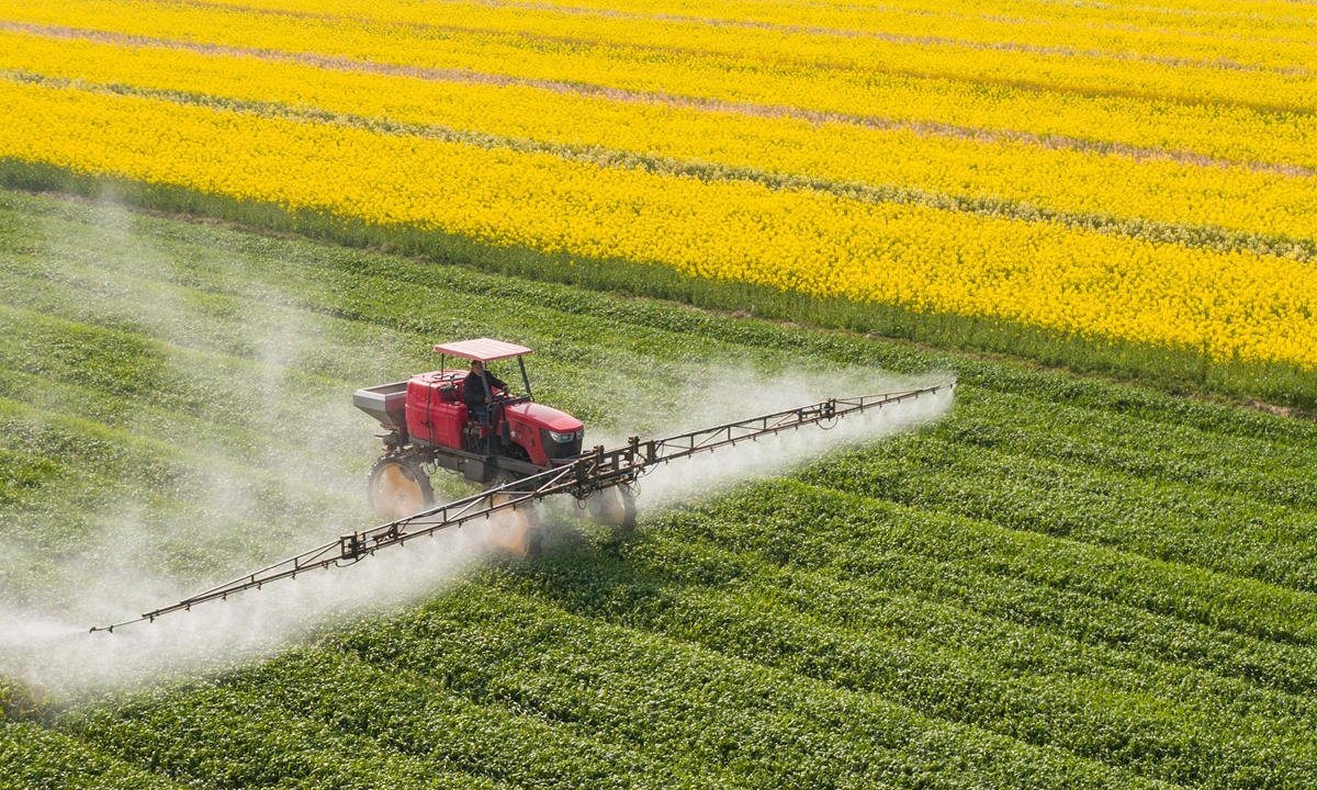 A farmer operates a pesticide sprayer over a wheat field in Nantong, East China's Jiangsu Province on March 23, 2022. The Chinese government has allocated 20 billion yuan ($3.14 billion) to support farmers who grow grain, among other measures, according to the People's Daily. Photo: VCG